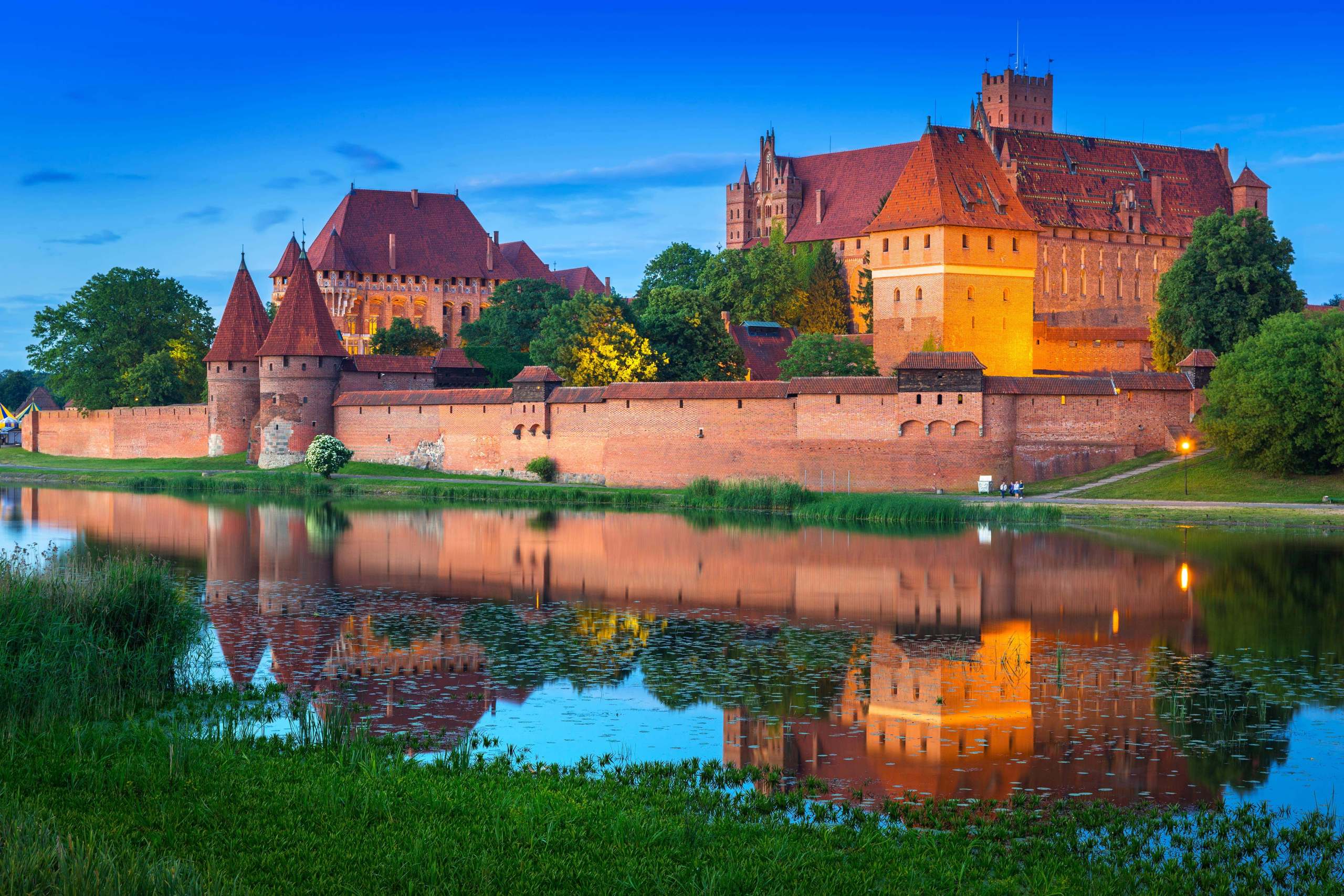 Malbork castle at dusk from the other side of the river.