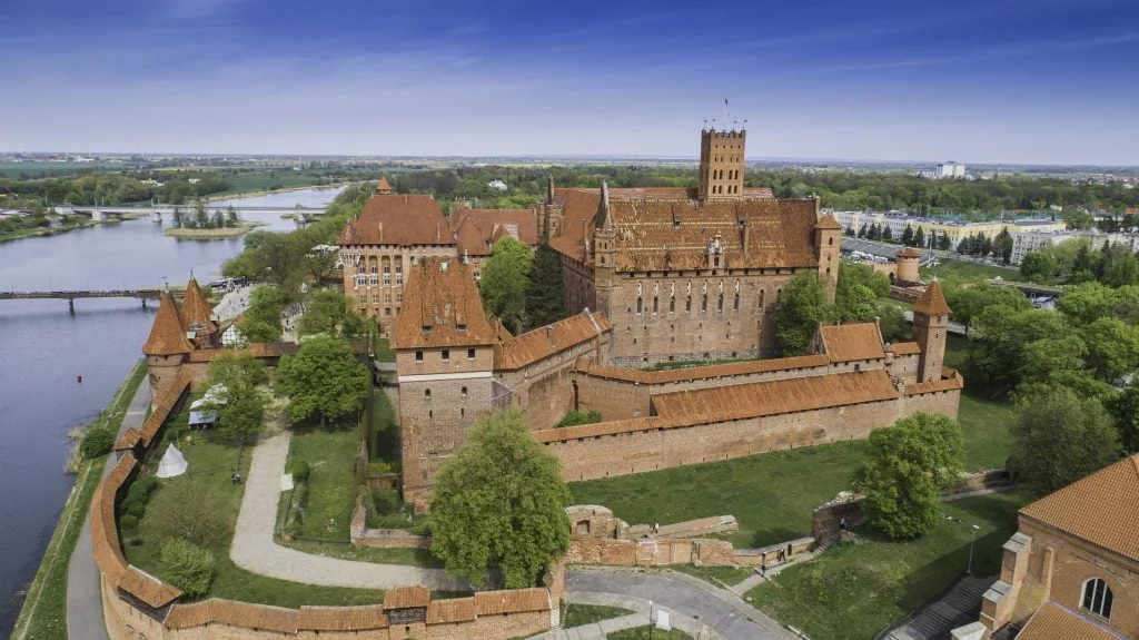 aerial shot of malbork castle from a side view