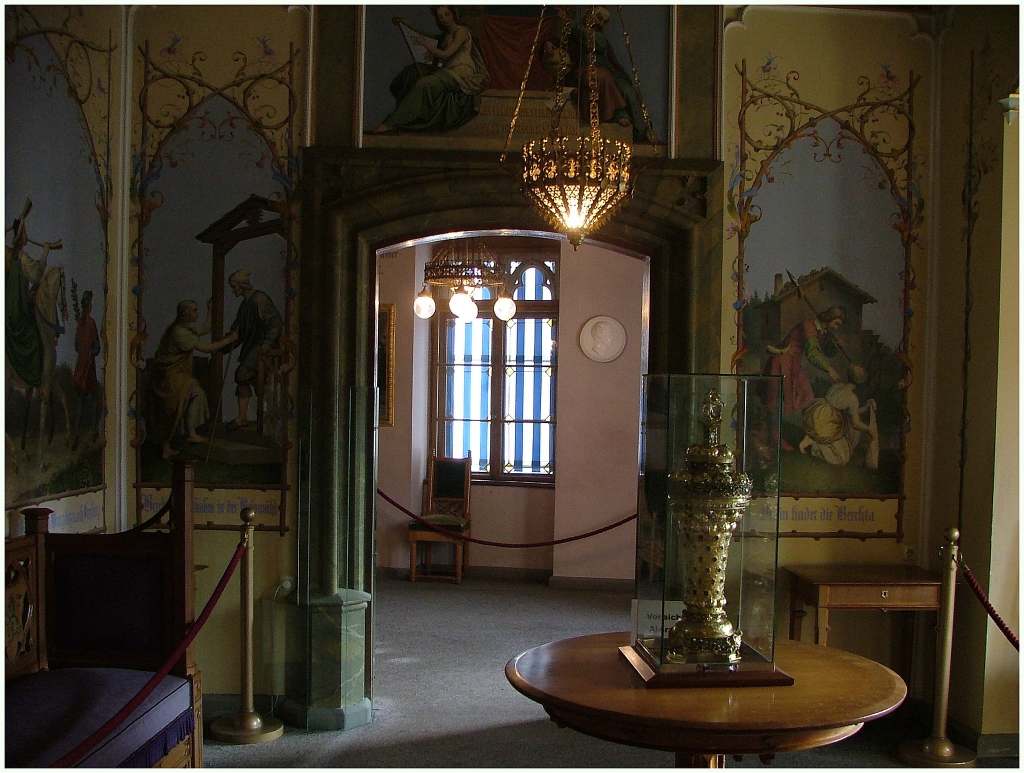 Hohenschwangau Castle sneak peek of its beautiful palace interior with a golden vase and wall paintings.