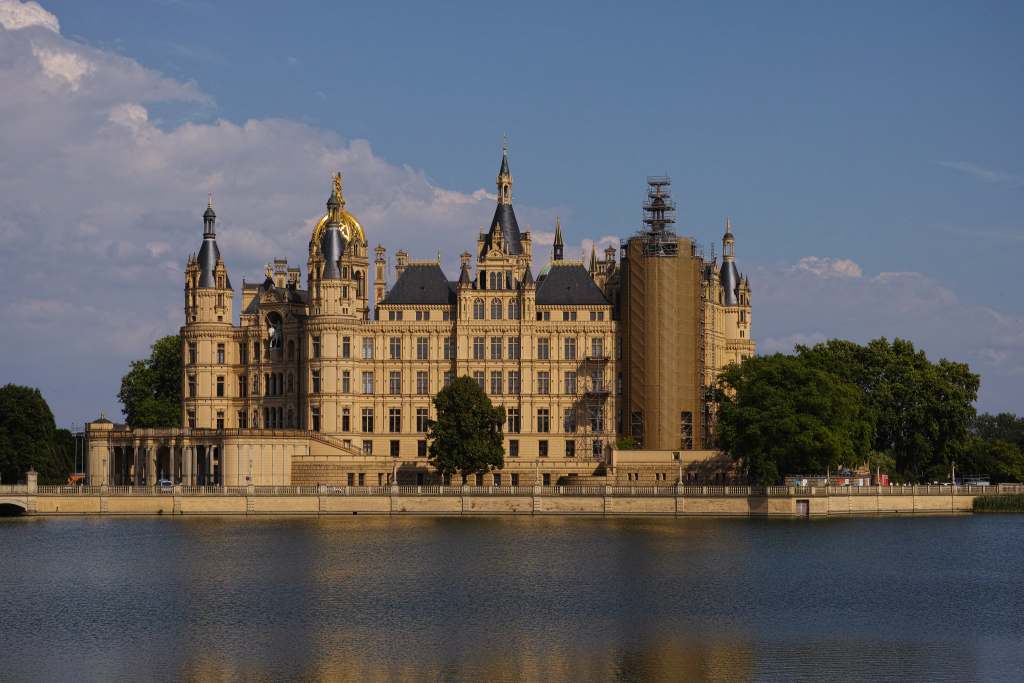 Lake front view of the Schwerin castle and its romantic architecture surrounded with few trees