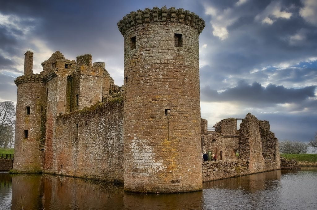 The triangular plan and surrounding moat of the Caerlaverock Castle