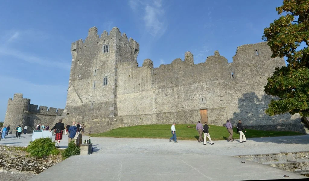Ross Castle surrounded by tourists outside.