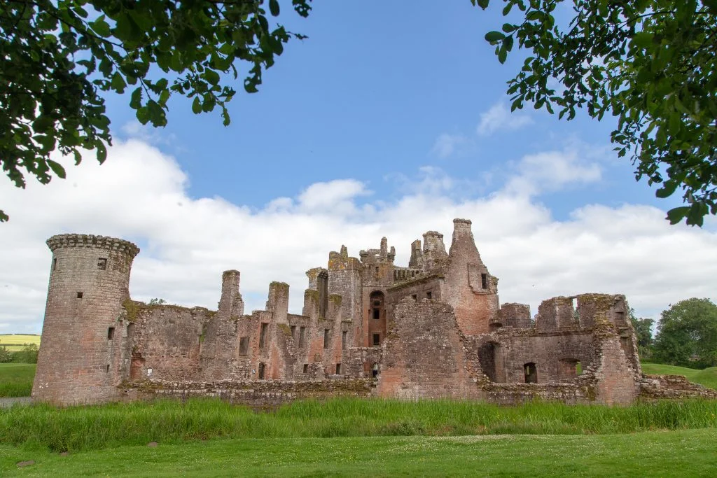 A look at the crumbling architecture of the castle and its green surroundings. 