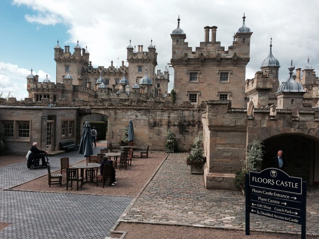 Floors castle entrance to the Gift Shop with tables and chairs in the middle. 