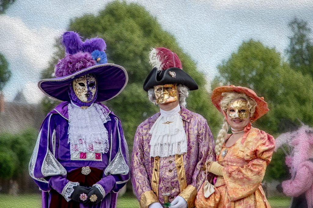 Parade de Masques at Chateau de Cheverny with three people wearing masks.