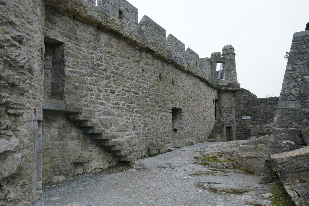 Ross Castle's interior with high stone wall.