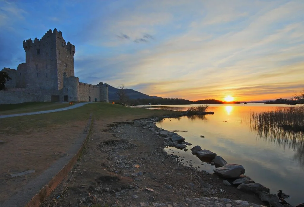 The beautiful sunset view of ross castle beside the river.
