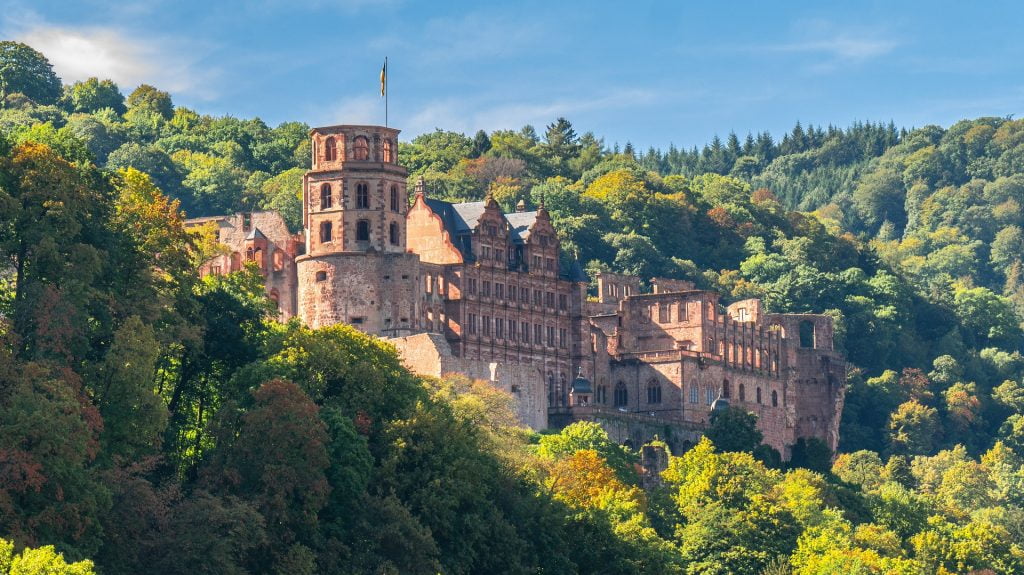 Heidelberg Castle view surrounded by green trees.