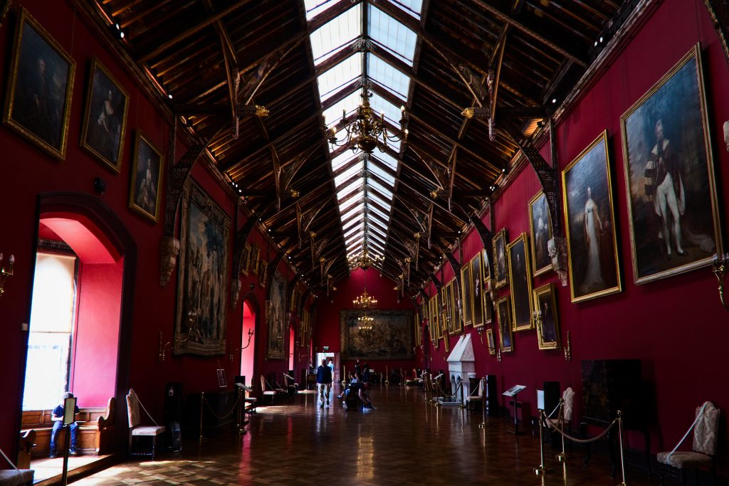 The Red Room inside Kilkenny Castle with portraits displayed.