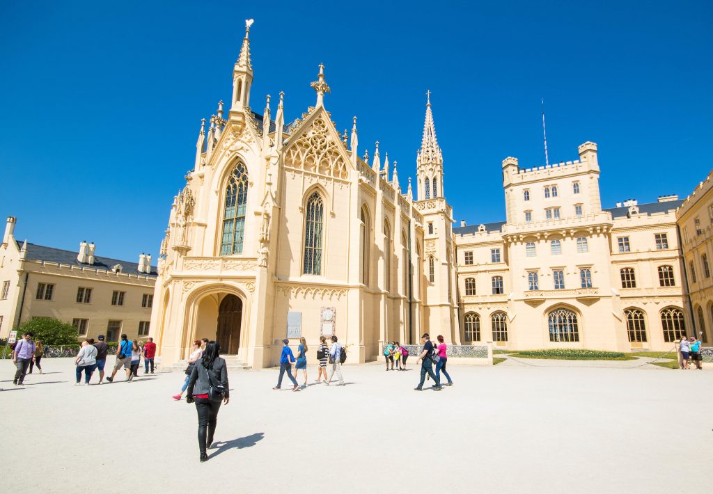 A close look of Lednice Castle with visiting tourists.