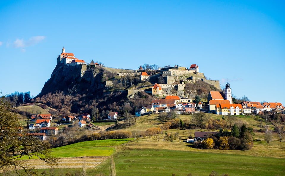 The hilltop location of Riegersburg Castle and the village that resides underneath it .
