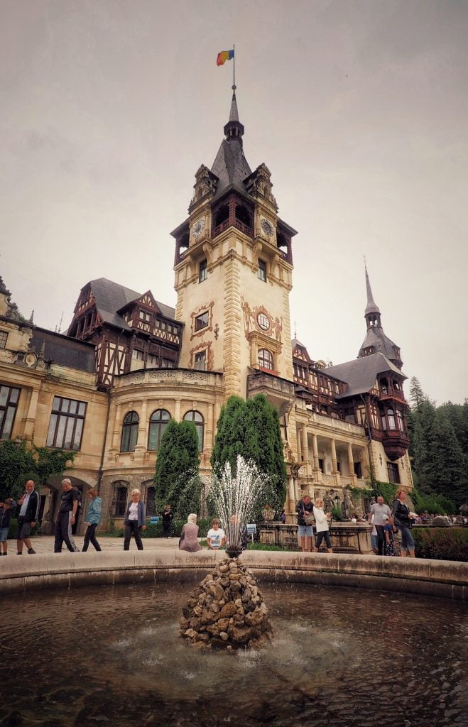 The tower of Peles Castle with the fountain.