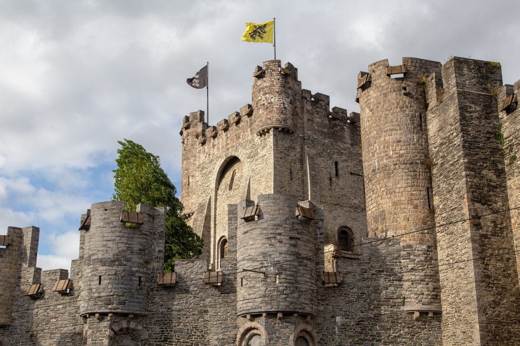An upclose view of Gravensteen Castle's tower structure.