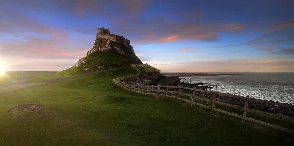 A panoramic view of Lindisfarne Castle with its rocky shores.