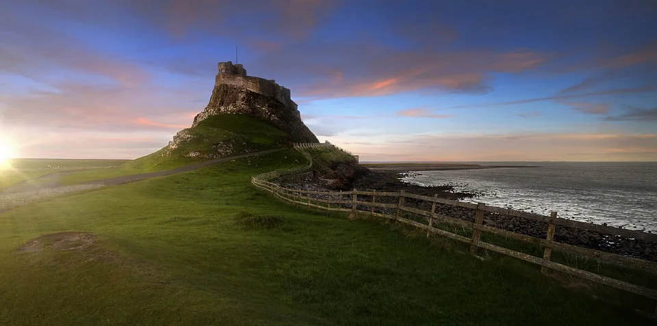 A panoramic view of Lindisfarne Castle with its rocky shores.