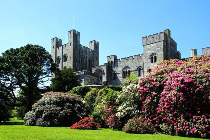 Penrhyn Castle surrounded with trees and flowers.