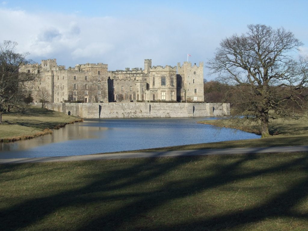 Side view of Raby Castle across the lake.