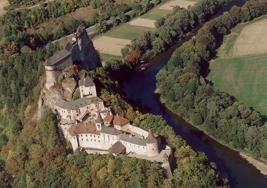 An aerial view of Orava Castle and its lush surroundings.