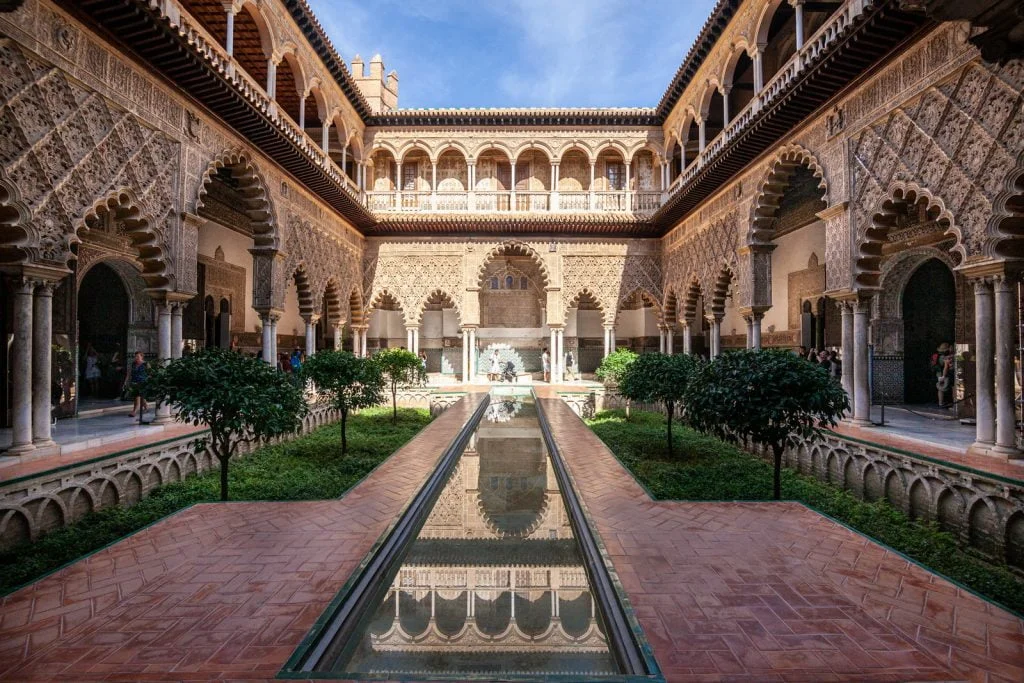 A photo of Alcazar of Seville's architectural structure. showing the details of the castle building.