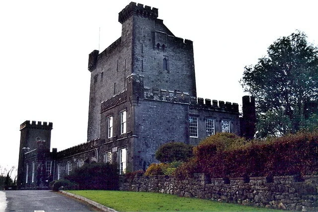 top 10 castles to visit in ireland The view of the side of Knapppogue Castle along the road.