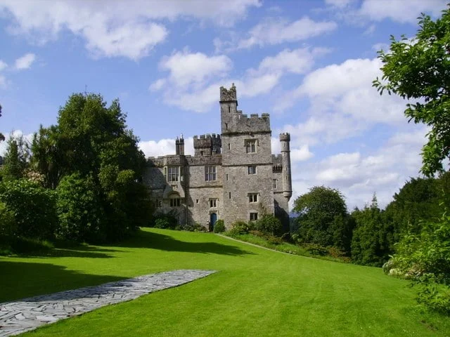 Lismore Castle's view surrounded by green trees and grasses. view surrounded by greens.