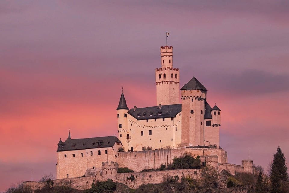 The stunning view of Marksburg Castle under pink skies.
