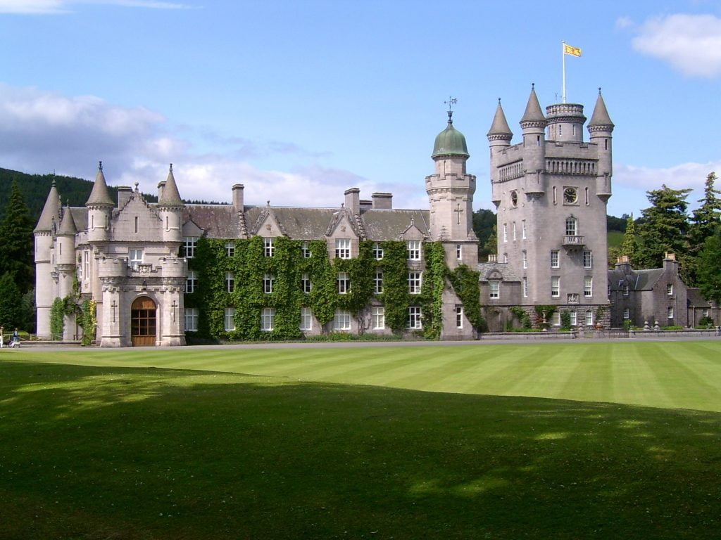 Balmoral Castle in front of the green grounds.