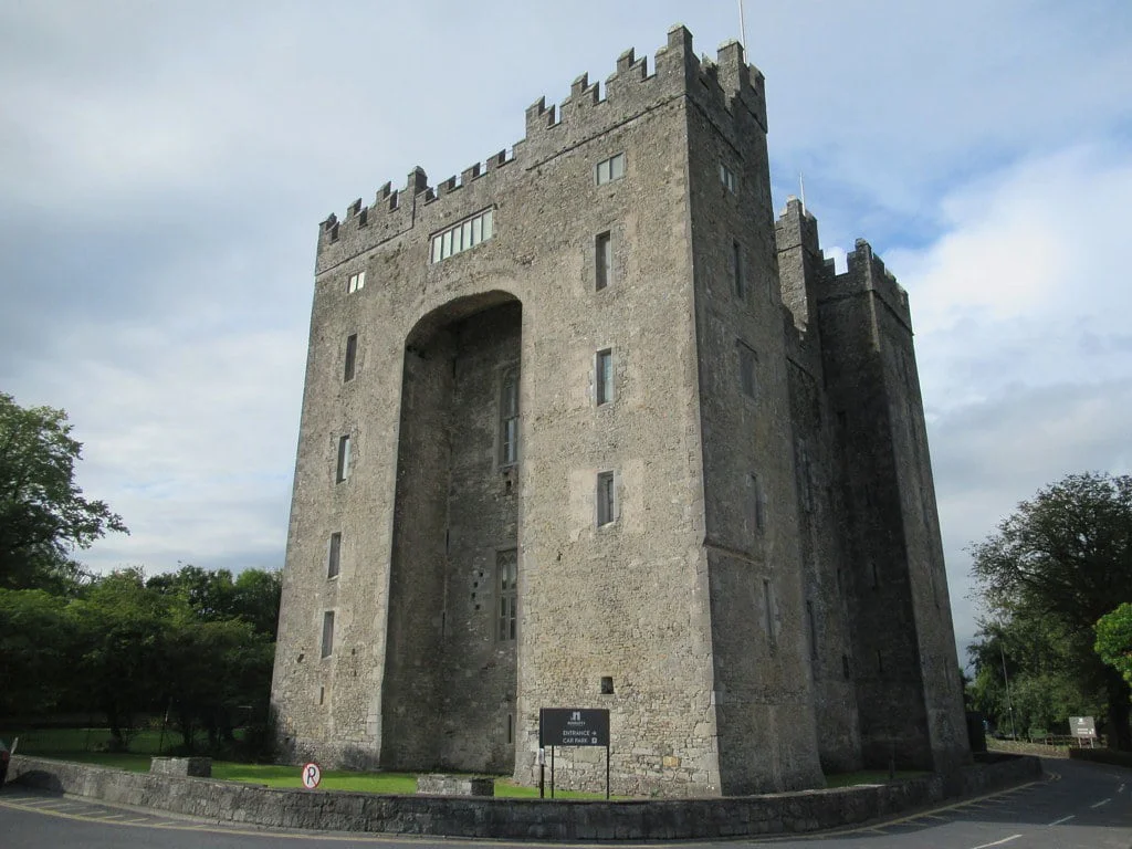 The tower of Bunratty Castle in the middle of the road. 