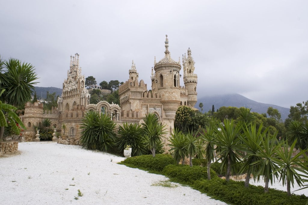 The view of Castillo de Colomares from afar with trees around the castle. 