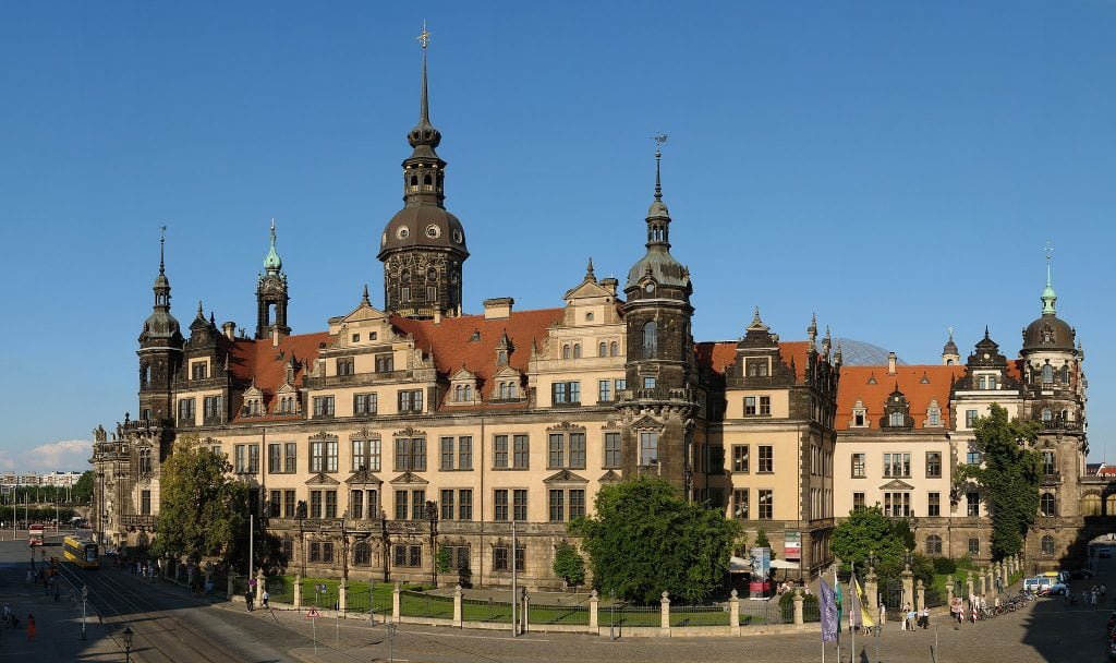 The front view of the amazing architectural structure and detail of Dresden Castle along the road. 