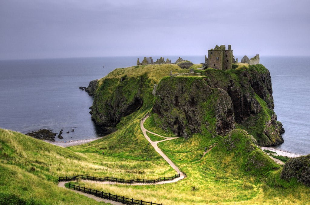 The stunning view of Dunnotar castle at the cliff surrounded by the sea.  