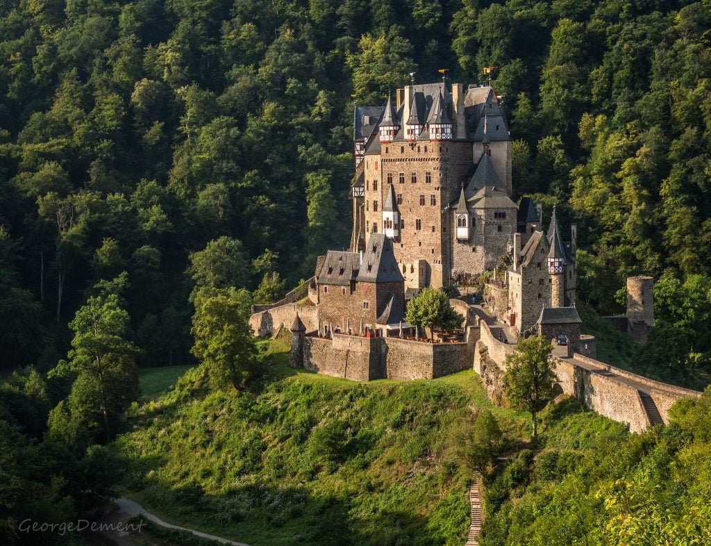 Eltz Castle's view from afar at the hilltop surrounded by trees.