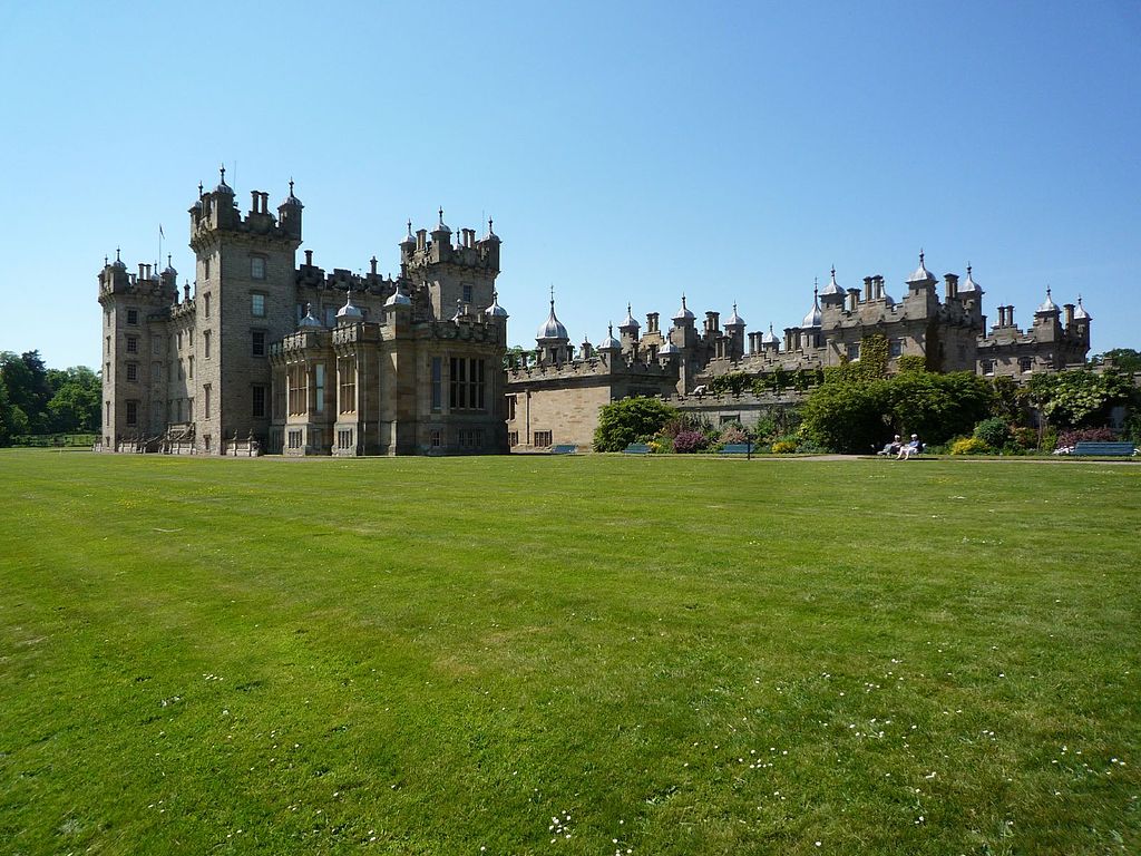 The panoramic view of Floors Castle in front of the green grounds.