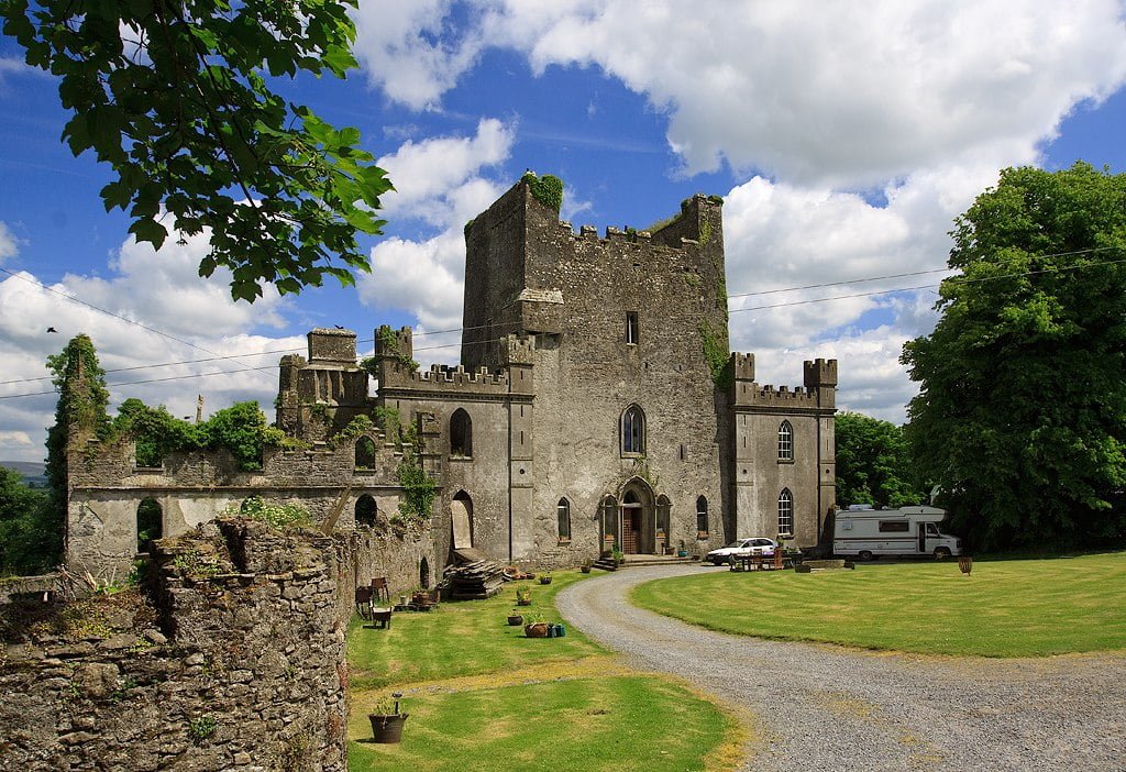 Front view of Leap Castle and its green castle ground.