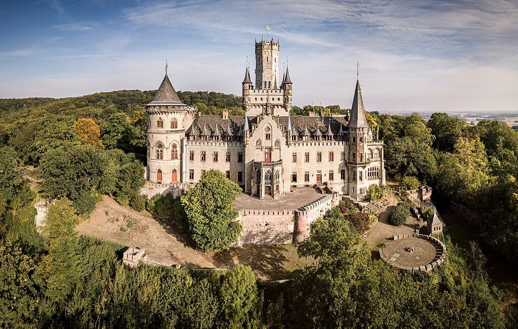 The picture perfect majestic view of Marienburg Castle surrounded by trees.