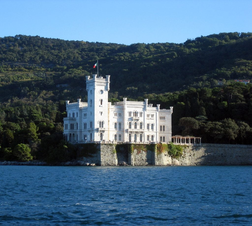 Miramare Castle standing beautifully at the edge of the bay.