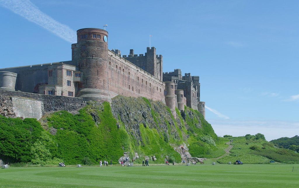Bamburgh Castle standing tall atop its cliffside.