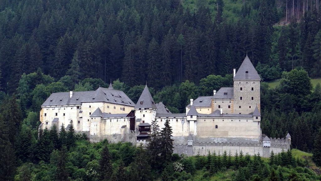 Moosham Castle's view from afar in the middle of pinetrees.