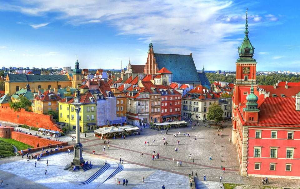 The Royal Castle in Warsaw with visiting tourists around.