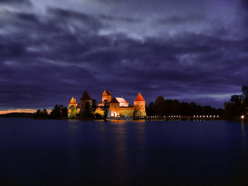 Trakai Island Castle illuminated during late dusk.