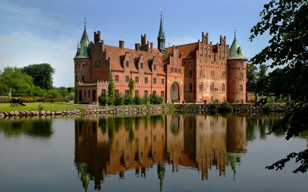 A picturesque view of Egeskov castle from across the river.