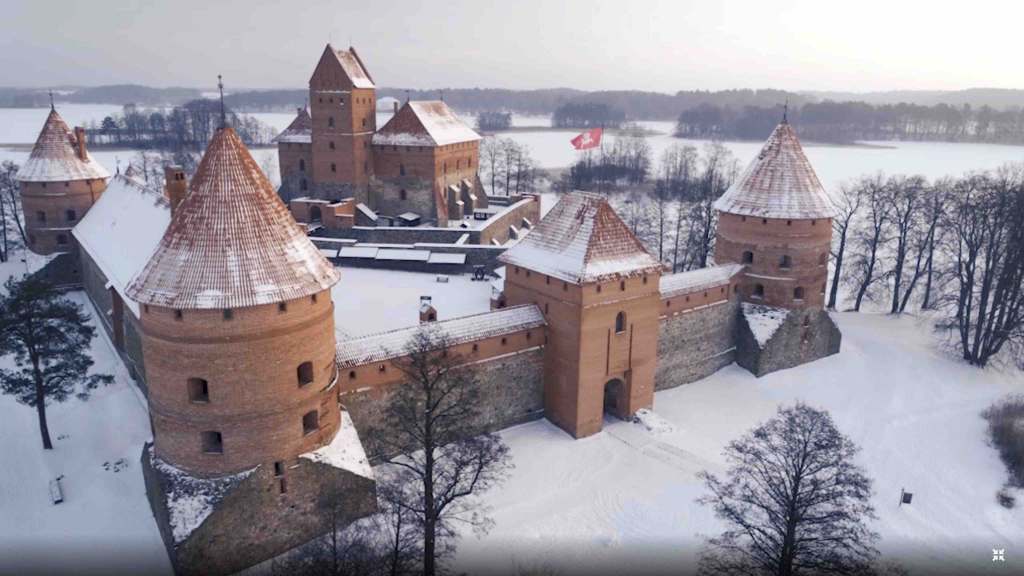 drone shote of trakai castle in lithuania covered in snow