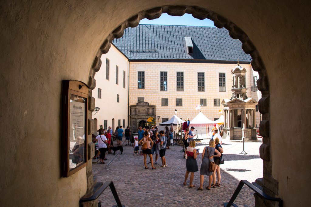 Tourists at Kalmar Castle's courtyard.