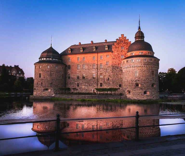 A stunning sunset view of Orebro Castle over Lake Hjalmaren.