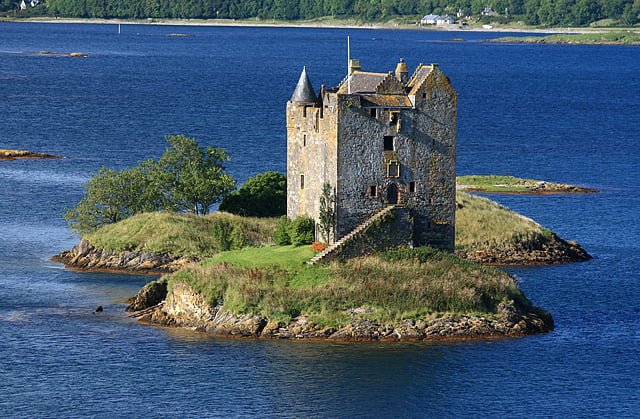 The authentic keep-style architecture of Castle Stalker in Scotland.