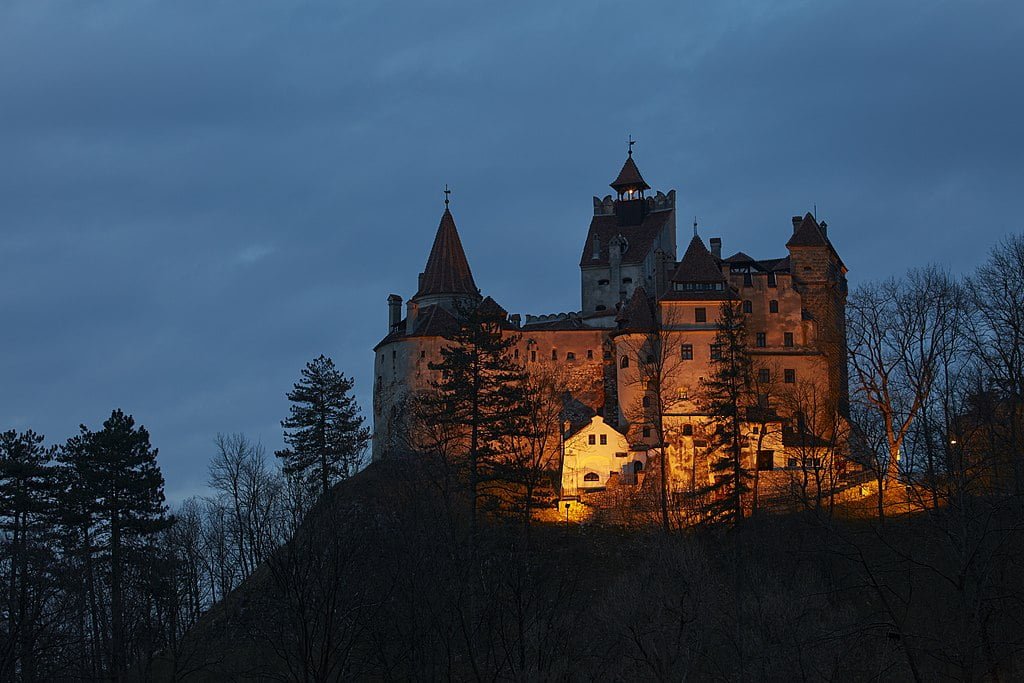 Bran Castle glowing in late dusk.