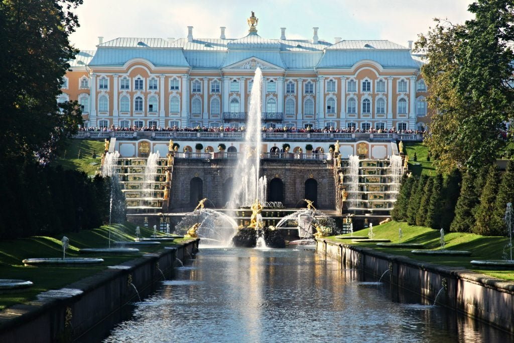 The beautiful view of Peterhof palace in front of the fountain.