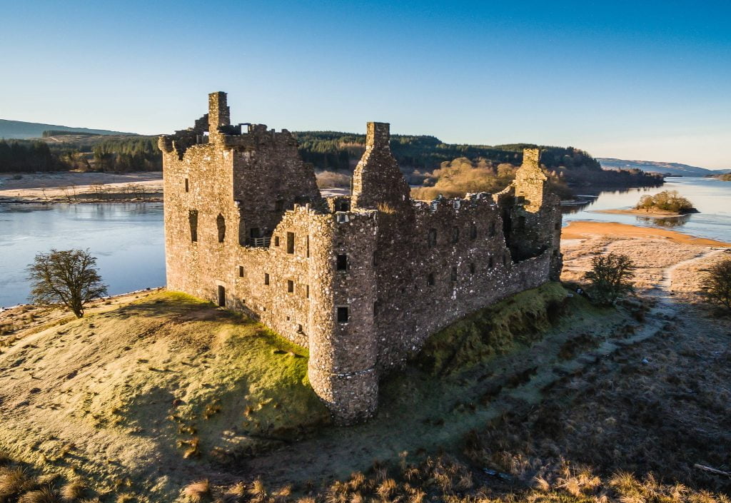 Kilchurn Castle's aerial view with blue sky.