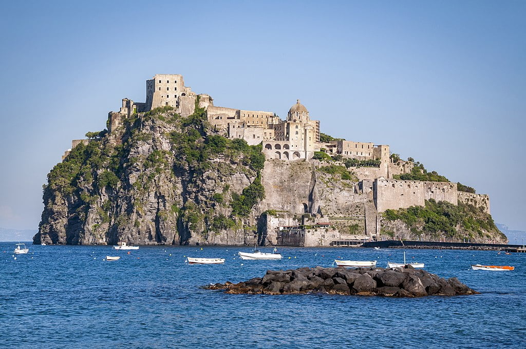 Aragonese Castle sprawling across an Italian cliffside.