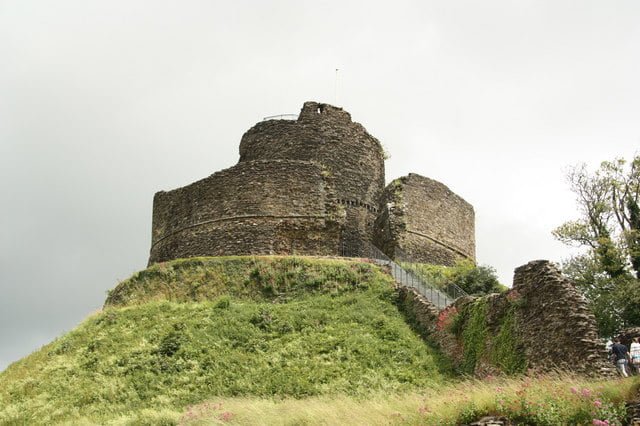 Launceston Castle with its curved stone wall, sitting atop its motte. 